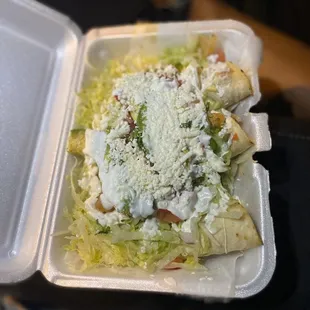 a close up of a taqueria in a styrofoam container