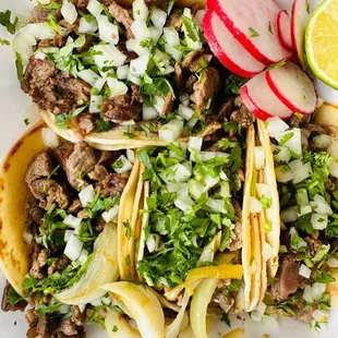 a plate of tacos and a lime