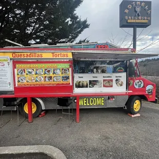 Taco truck with a seating area.