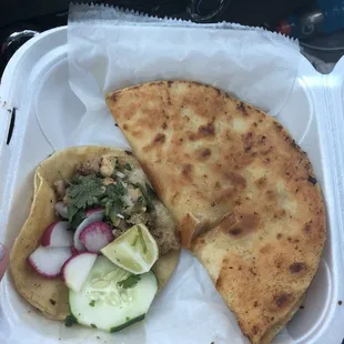 a close up of a taqueria in a styrofoam container