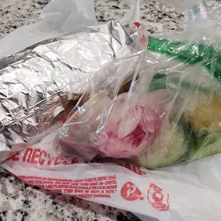 Wrapped carne asada burrito with garnishes