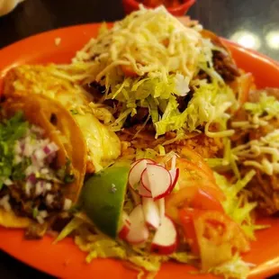 Combo plate steak taco, cheese enchilada and Al pastor tostada with all the trimmings.