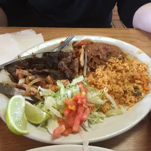 This is the Plato Mix a mixture of beef chicken fajitas with sausage, rice and beans and side salad for 6.99 today's special!