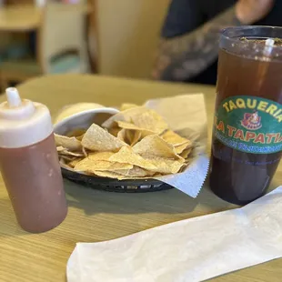 Chips with salsa and bowl to serve.  Tea and silverware.