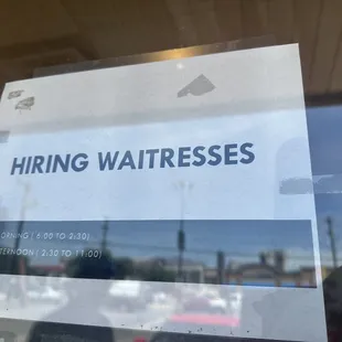 a sign for hiring waitresss