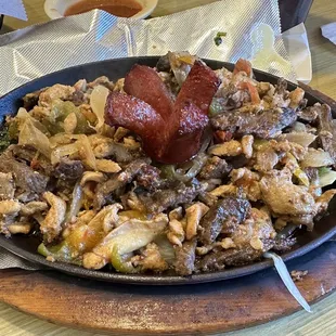 Parrillada Azteca: several meats over mixed and overcooked.  Taste: daysss old leftovers  Gave it back &amp; they took my rice and beans