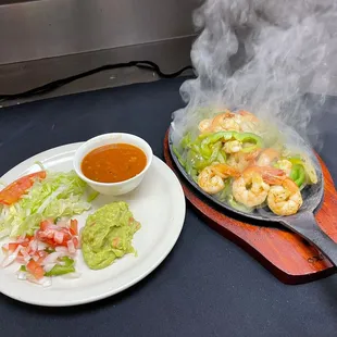 a plate of food with shrimp and guacamole