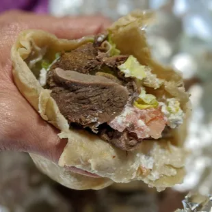 a hand holding a taqueria
