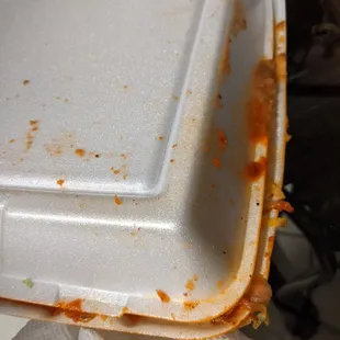 a close up of a white take out container