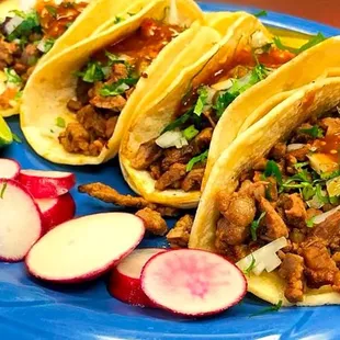 three tacos on a blue plate