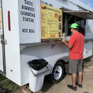 a man ordering food from a food truck