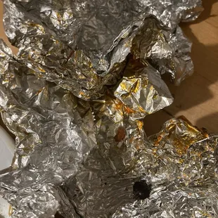 Grease pooling in the foil after saturating every bit of the tortilla.