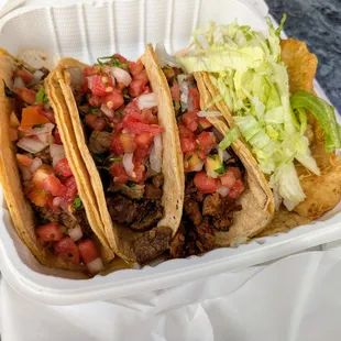 Carne Asada (Steak, $5.25), Al Pastor (Marinated Pork, $5.00), Carnitas (Pork, $5.00), and Fish (Tilapia, $5.25) Tacos.