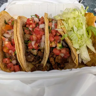 Carne Asada (Steak, $5.25), Al Pastor (Marinated Pork, $5.00), Carnitas (Pork, $5.00), and Fish (Tilapia, $5.25) Tacos.