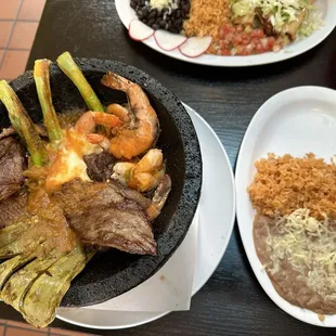 Mar y Tierra (Steak &amp; Shrimp) Molcajete w rice &amp; beans (refried here) &amp; tortillas.  Large portion for sharing.  Tastes amazing!!