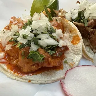 Cochinita pibil, regular taco on the left.  Carnitas regular taco on the right