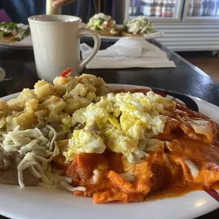 Chilaquiles Rojos plate added cheese and eggs