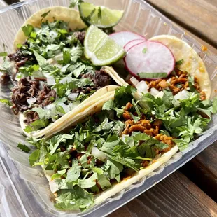 two tacos in a plastic container