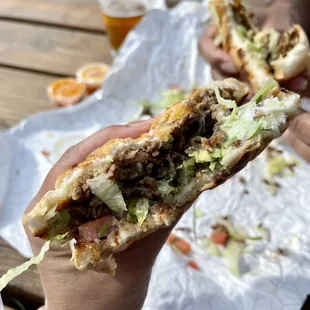 a hand holding a sandwich