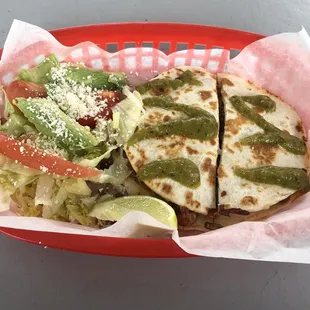 a taco and salad in a basket