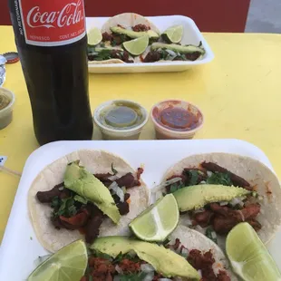 a plate of tacos and a coke