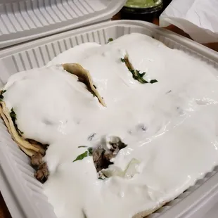 Good thing I didn't order extra sour cream... There are 5 street tacos under here somewhere