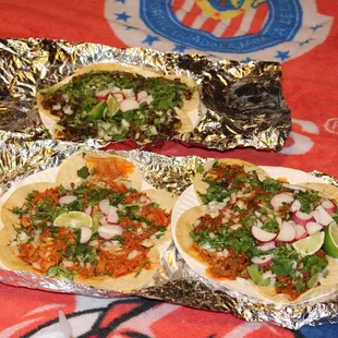 three tacos on foil