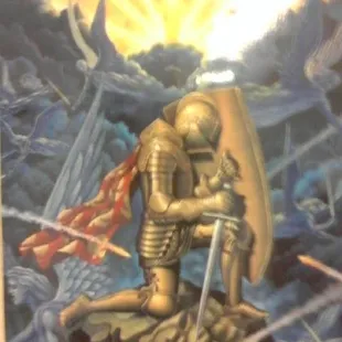 a statue of a knight holding a flag