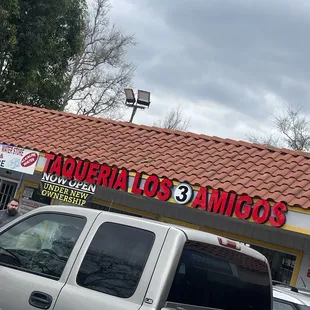 a truck parked in front of a restaurant