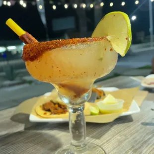 Margarita with tacos behind it.