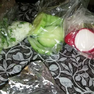 To go orders come with bags with cilantro and onion, cucumber, and radishes.