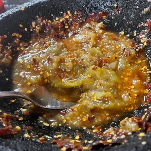 a bowl of chili sauce with a spoon