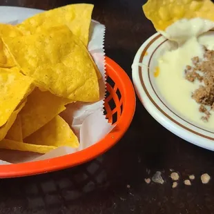 Queso with ground beef and chips.