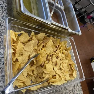 Self service salsa bar with free tortilla chips.