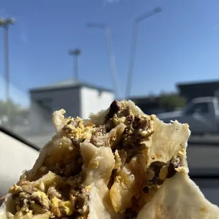 a hand holding a burrito