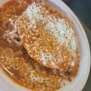 2 carnitas enchiladas... uniquely folded in half filled with meat &amp; cheese and covered in red sauce.  DELICIOUS