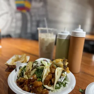 a plate of tacos and a drink