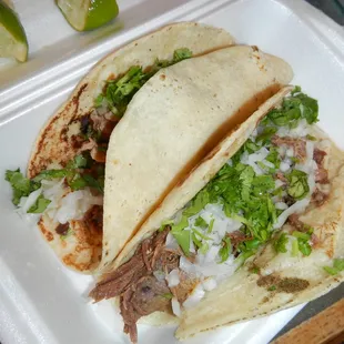 Two tacos barbacoa (take out.) The meat&apos;s a little bit bland but still pretty decent.