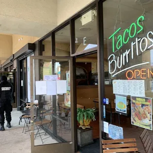 the entrance to a taco's burritos restaurant