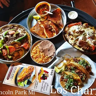 a tray of tacos and other dishes