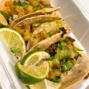 three tacos in a styrofoam container