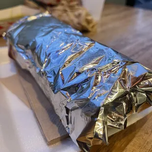 a burrito wrapped in aluminum foil