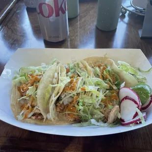 Grilled chicken tacos, no cilantro, lettuce added, with hot sauce. Lime and radishes on the side.