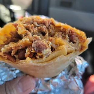 Breakfast burrito made the way I like it. Chorizo, bacon, cheese, rice, a little bit of potato, and pico.