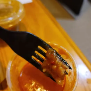 Carb pieces inside chilli salsa.