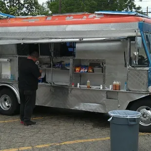a man standing in front of a food truck