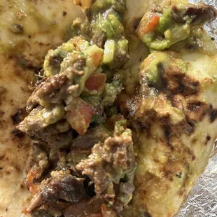 a tortilla with meat and vegetables