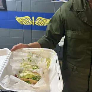 a man holding a tray of food