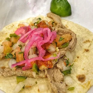 a taco with meat and onions