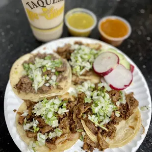 Al pastor tacos (with one Asada on the far left), horchata, red and green salsa